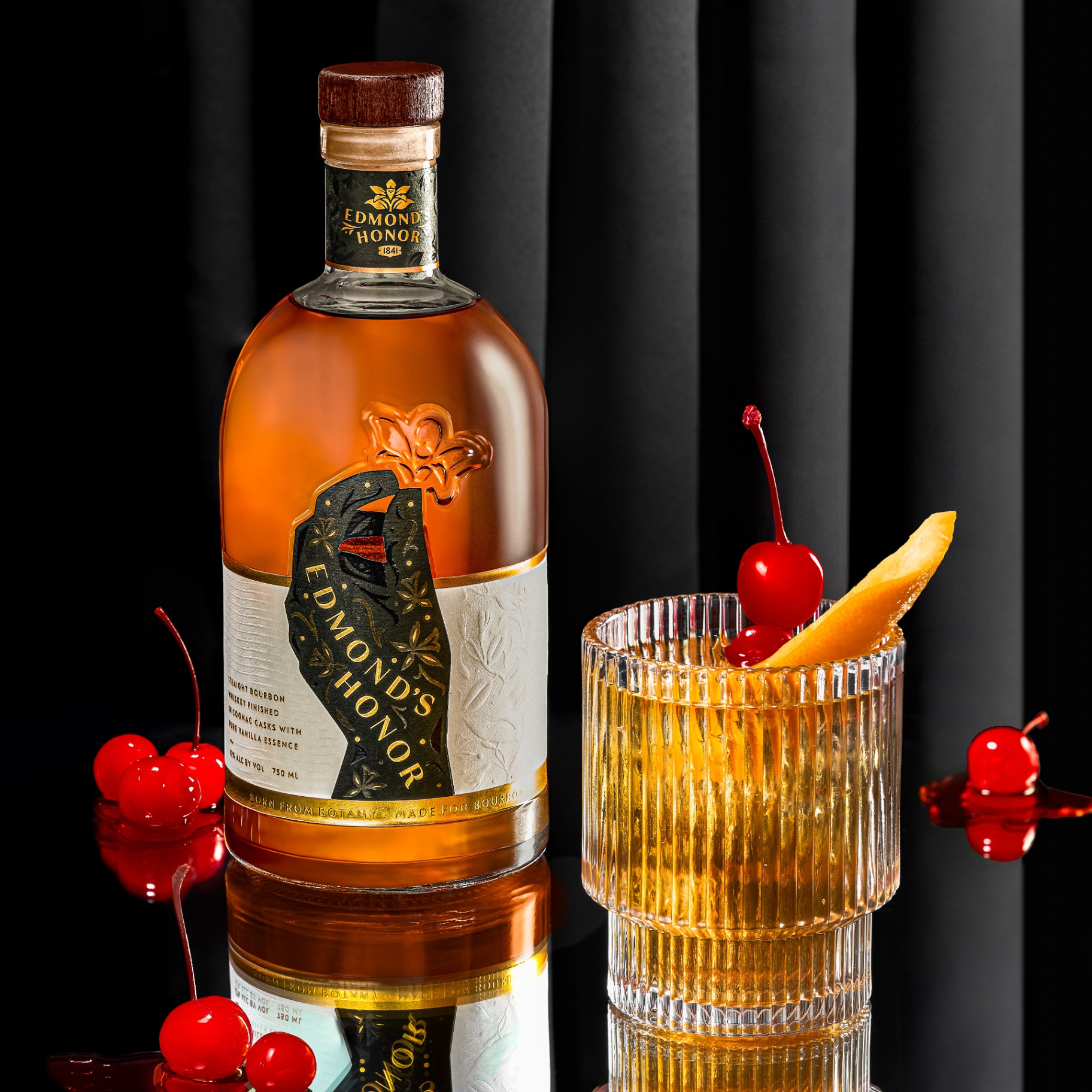 Edmond's Honor bottle and cocktail in candlelight