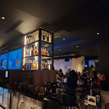 A members club lounge with leather seating and warm amber lighting