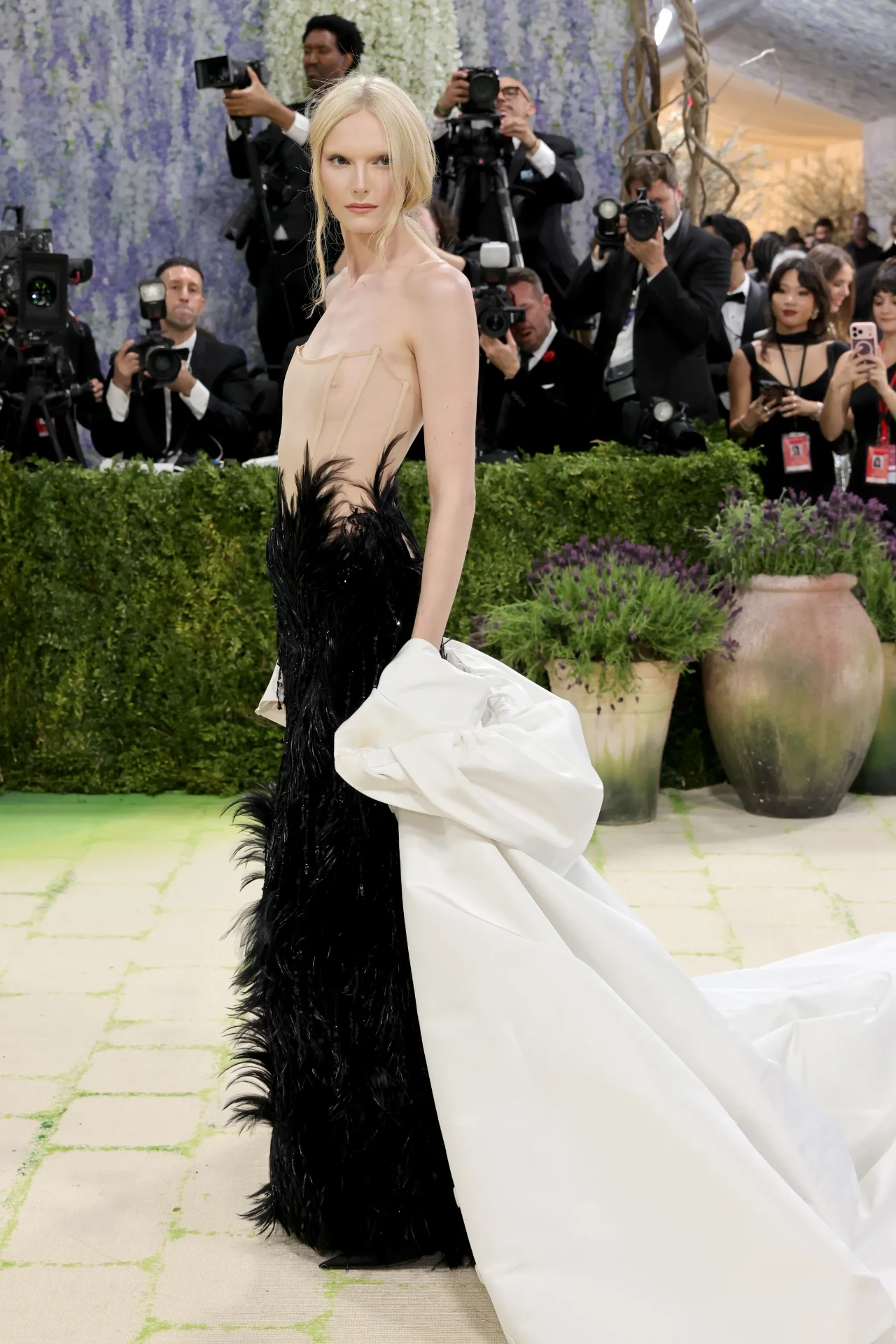 Black feathered corset gown with sculpted ivory train
